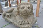 Steinskulptur liegender Wächterlöwe